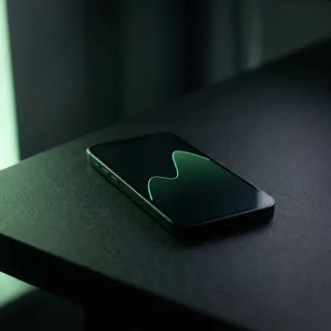 A phone showing a rising green curve